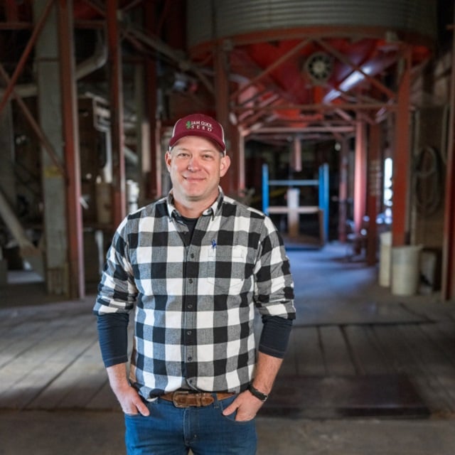 Man standing in grain facility