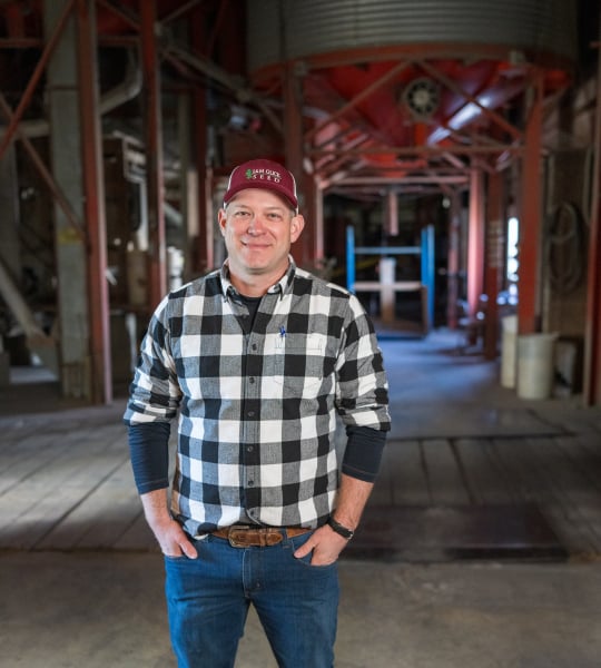 Man standing in grain facility