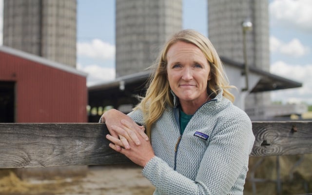 Cattle farmer standing in front of barn