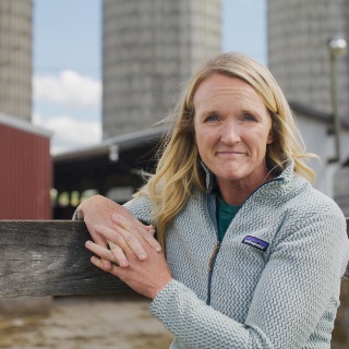 Cattle farmer standing in front of barn