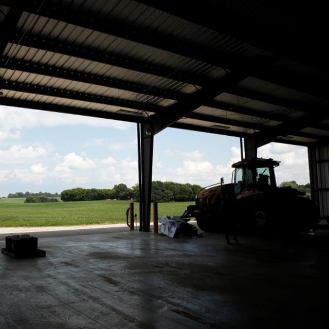 Machine shed overlooking soybeans.