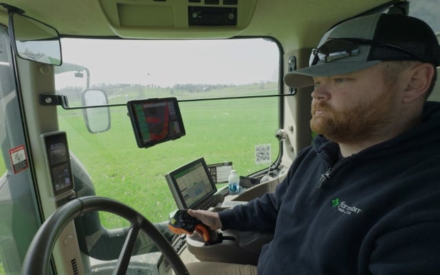 Farmer driving farm equipment