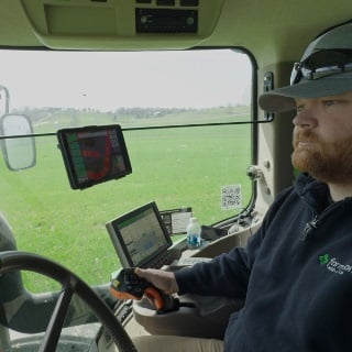 Farmer driving farm equipment