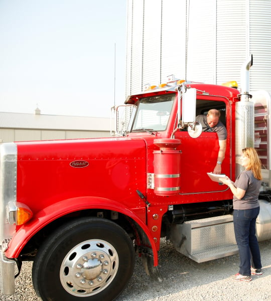 Red semi hauling grain.